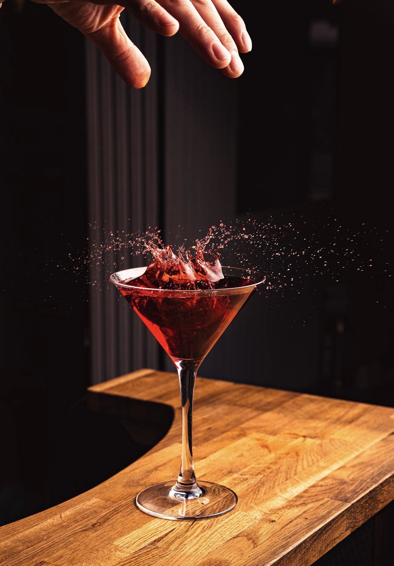 A signature red cocktail captured in motion
